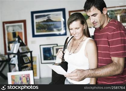 Mid adult couple standing in a paintings store