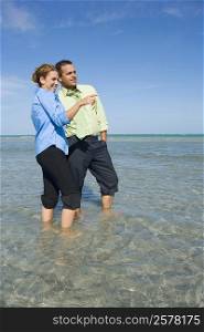 Mid adult couple standing in water