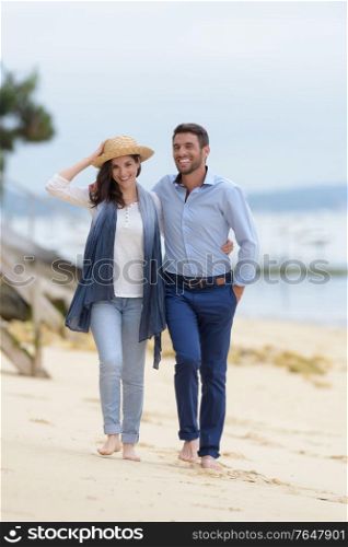 mid-adult couple walking on beach