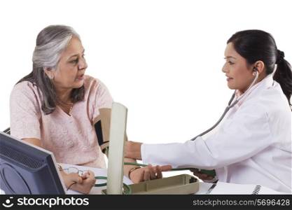 Mid adult doctor checking patient&rsquo;s blood pressure