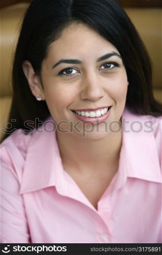 Mid adult Hispanic woman smiling at viewer.
