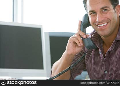 Mid-adult male office worker on the phone