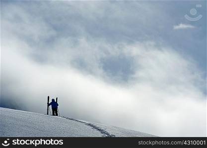 Mid adult male skier standing on hill, Obergurgl, Austria