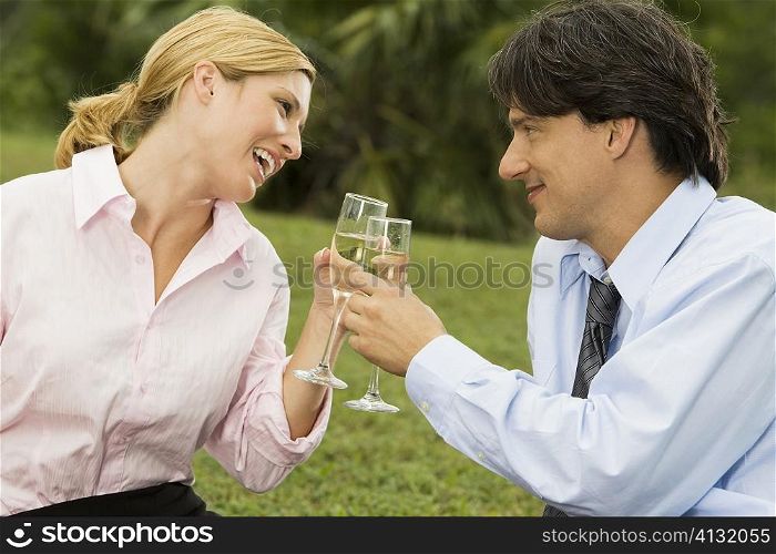 Mid adult man and a young woman holding champagne flutes