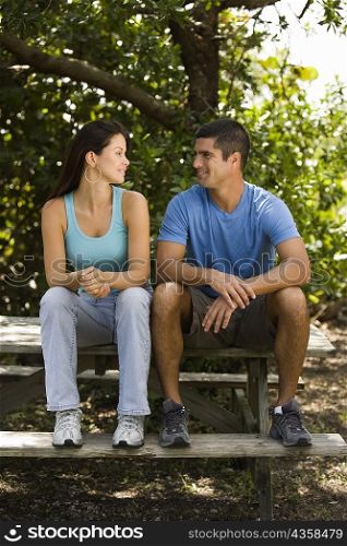 Mid adult man and a young woman looking at each other