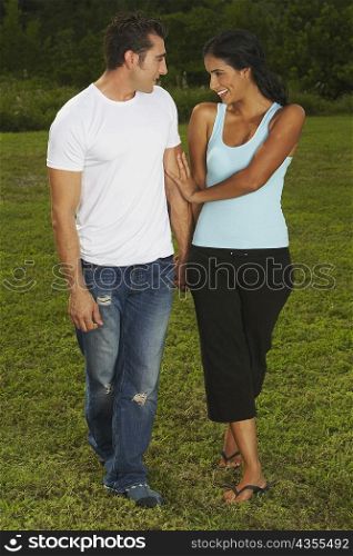Mid adult man and a young woman looking at each other and smiling