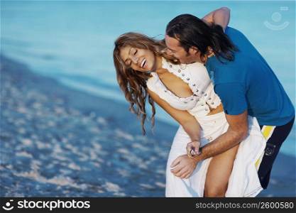 Mid adult man and a young woman on the beach