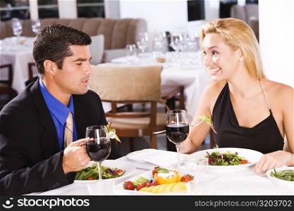 Mid adult man and a young woman sitting in a restaurant