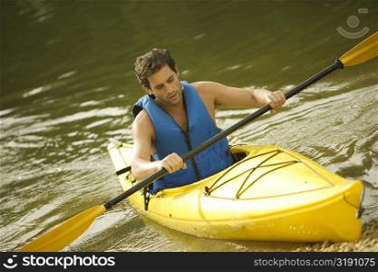Mid adult man boating in a lake