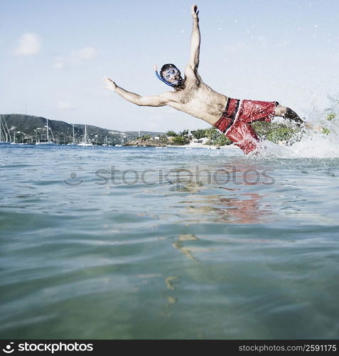 Mid adult man diving in water