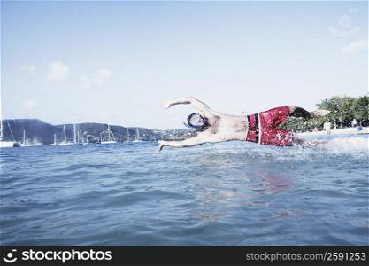 Mid adult man diving in water