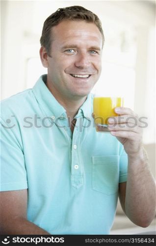 Mid Adult Man Drinking Orange Juice