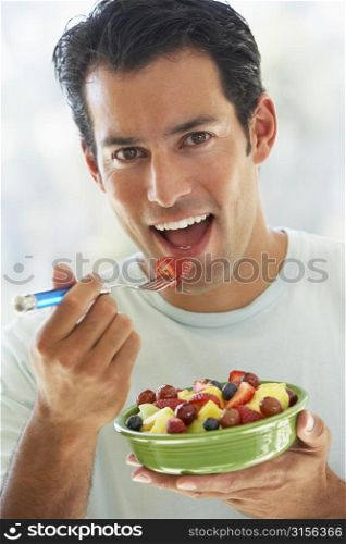 Mid Adult Man Eating Fresh Fruit Salad
