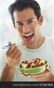 Mid Adult Man Eating Fresh Fruit Salad