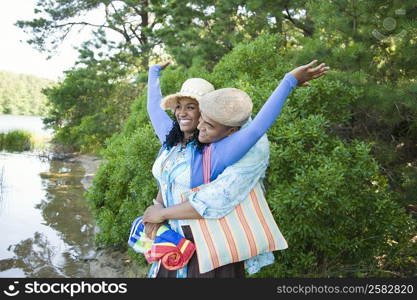 Mid adult man embracing a young woman from behind