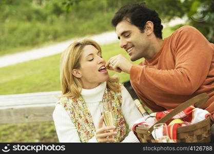 Mid adult man feeding a young woman