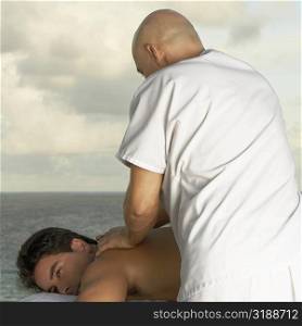 Mid adult man getting a back massage
