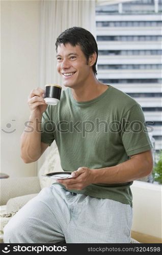 Mid adult man holding a cup of tea
