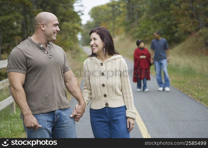 Mid adult man holding hand of a mature woman and smiling