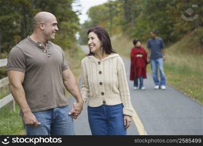 Mid adult man holding hand of a mature woman and smiling