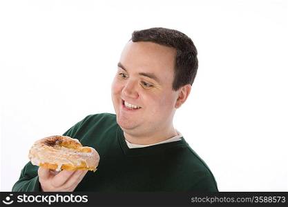 Mid-adult man holding pastry