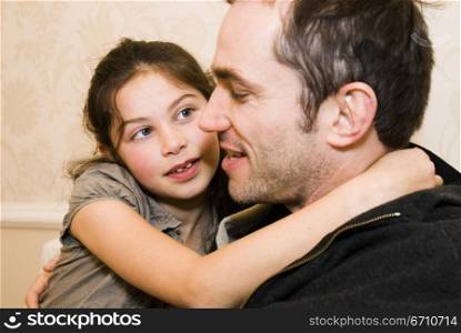 Mid adult man hugging his daughter