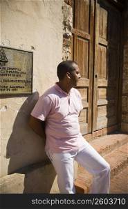Mid adult man leaning against a wall, Santo Domingo, Dominican Republic