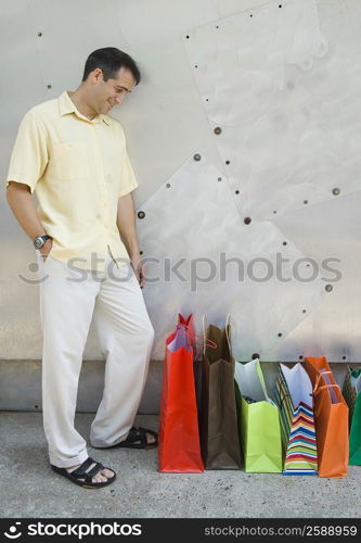 Mid adult man looking at bags and smiling