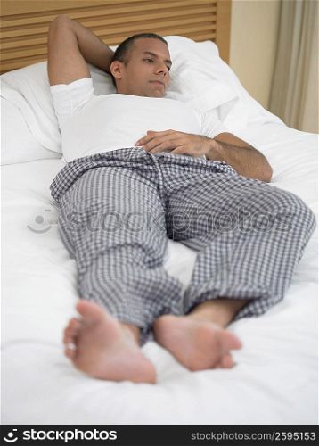 Mid adult man lying on the bed