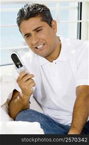 Mid adult man operating a mobile phone