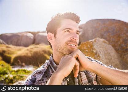 Mid adult man, outdoors, looking away in thoughtful pose
