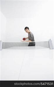 Mid adult man playing table tennis