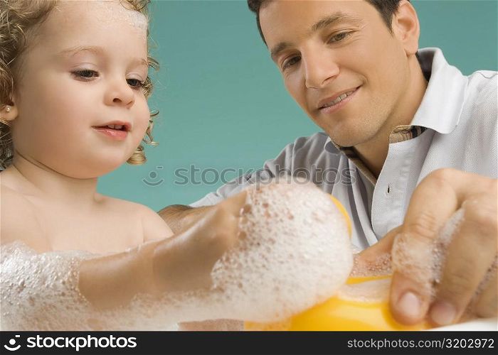 Mid adult man playing with his daughter