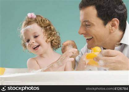 Mid adult man playing with his daughter