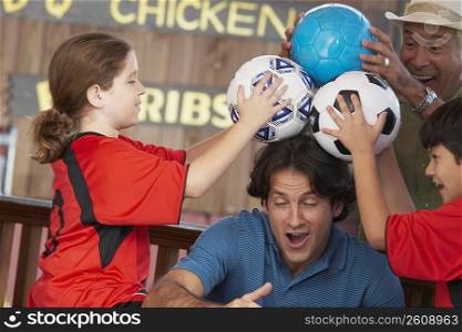 Mid adult man playing with his family in a restaurant