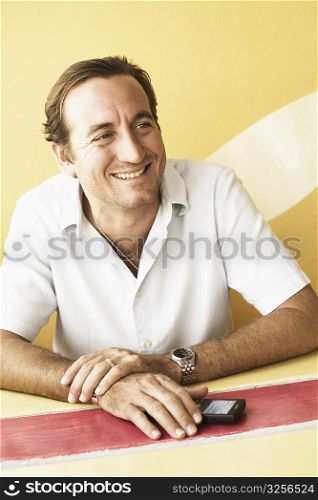 Mid adult man sitting in a restaurant and smiling