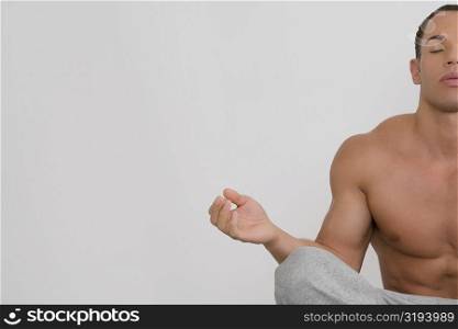 Mid adult man sitting in a yoga position