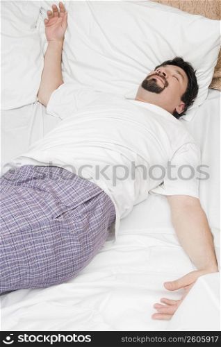 Mid adult man sleeping on the bed