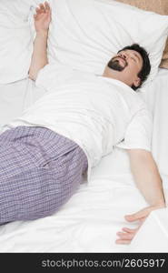 Mid adult man sleeping on the bed