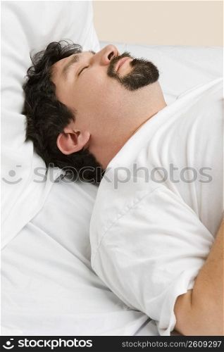 Mid adult man sleeping on the bed