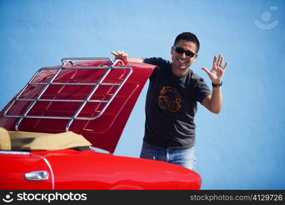 Mid adult man standing behind a convertible car, Miami, Florida, USA