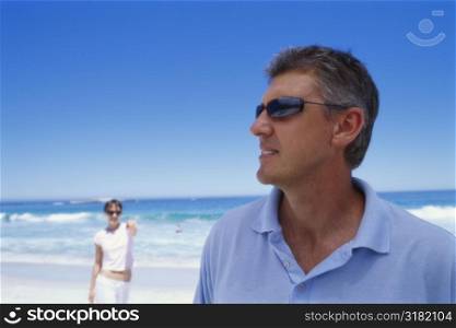 Mid adult man standing on the beach