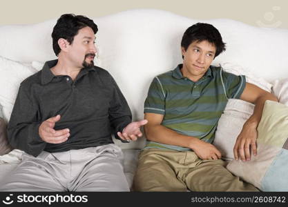 Mid adult man talking to his son