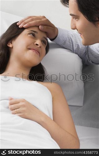 Mid adult man touching a young woman&acute;s head