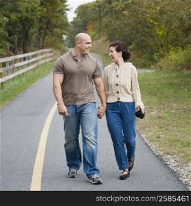 Mid adult man walking on the road with a mature woman and smiling