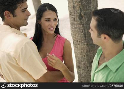 Mid adult man with a young woman and a young man looking at each other