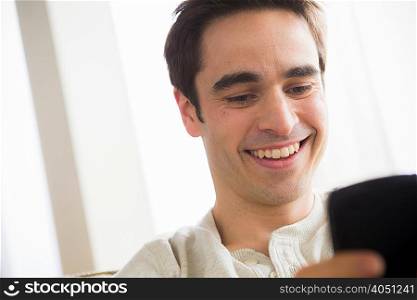 Mid adult man with cell phone, smiling