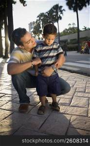 Mid adult man with his son, Malecon, Santo Domingo, Dominican Republic
