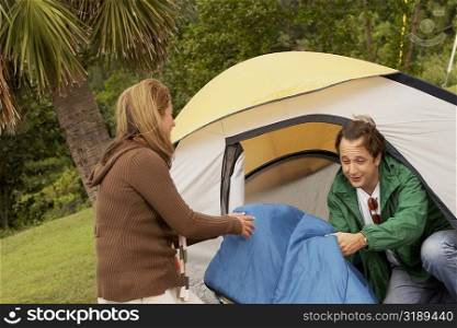Mid adult woman and a mature man camping