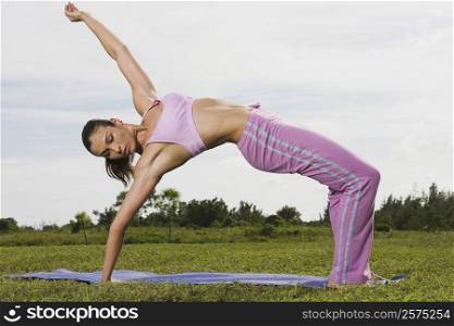 Mid adult woman bending over backwards